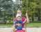 Mother and cute little child boy having fun on a swing in the park. Funny outdoor activity for family and children, in sunny