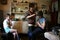 Mother cuts hair son in kitchen of rural house, Russia.