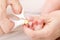 Mother cuts newborn baby toenails