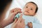 mother cutting baby\\\'s hand fingernails with nail scissors