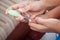 Mother cutting fingernails for her baby