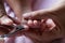 Mother cutting nails with scissors to the baby.