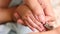 Mother cutting newborn baby`s nails