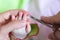 Mother is cutting tiny nails neatly and gently on the hand of newborn using nail scissors . Concept of care mom for baby