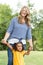 Mother and daugher laughing and playing at the park.