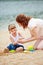 Mother and daugher playing in sand