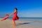 Mother and daugher playing on summer beach