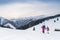 Mother with daugher walking hand in hand by snow moontain trail. Active outdoor time spending concept image