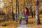 Mother and daughter against the background of autumn. Autumn happiness.