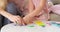 Mother with daughter assembling toy blocks at home