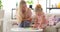 Mother with daughter assembling toy blocks at home