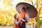 Mother and daughter are in autumn city park. Peoples are posing under umbrella. Children and parents are smiling, playing and havi