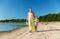 Mother and daughter with ball walking along beach