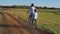 Mother with daughter on bicycles in a meadow. Family on bicycles in nature. The concept of the family.