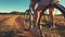 Mother with daughter on bicycles in a meadow. Family on bicycles in nature. The concept of the family.