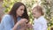 Mother and daughter blow bubbles