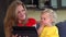 Mother with daughter blow throw a kiss to father on tablet video conversation