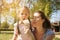 Mother and daughter blowing dandelion. Single mother enjoying w