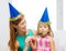 Mother and daughter in blue hats with favor horns