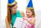 Mother and daughter in blue hats with gift box
