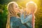 Mother and daughter with braiding hair. Nice child girl with plaits. Hair in trendy weave plait.