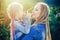 Mother and daughter with braiding hair. Nice child girl with plaits. Hair in trendy weave plait.