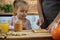 Mother and daughter breakfast in the kitchen. Mommy make sandwich her daughter