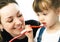 Mother and daughter brushing teeth