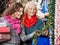 Mother And Daughter Buying Christmas Decorations