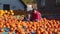 Mother and daughter buying pumpkin at market