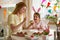 Mother and daughter celebrating Easter, cooking cupcakes,