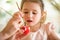 A mother and daughter celebrating Easter, painting eggs with brush