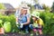 Mother and daughter child planting strawberry seedlings in summer