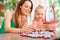 Mother And Daughter With Chocolate Easter Eggs And Basket