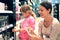 Mother and daughter choose perfume in perfume shop