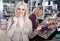 Mother and daughter choosing lipstick on display and smiling