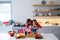 Mother and daughter chopping vegetables in kitchen