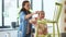 mother and daughter cleaning old wooden chair