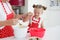 Mother and daughter cooking cupcakes into a large bright kitchen