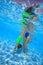 Mother and daughter dive in the swimming pool