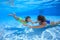 Mother and daughter dive in the swimming pool