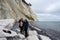 A mother and daughter with a dog in front of a beautiful chalk cliff
