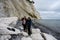 A mother and daughter with a dog in front of a beautiful chalk cliff