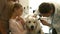 Mother and daughter with dog in the vets