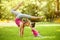 Mother and daughter doing exercise outdoors.