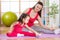 Mother and daughter doing fitness exercises on mat at home