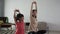 mother and daughter doing sport exercise at at home with her daughter together