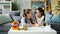 Mother and daughter drawing together at home talking bonding at table in house