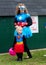 A mother and daughter dress in super women costumes during a Halloween event