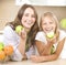 Mother with Daughter eating Apples